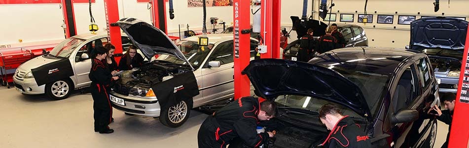 Cars in a garage being worked on
